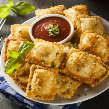 Air Fryer Fried Ravioli with tomato sauce on side